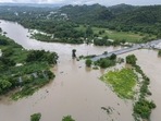 La Plata river floods a road after Tropical Storm Ernesto passed through Toa Baja, Puerto Rico, Wednesday, Aug. 14, 2024. (AP Photo/Alejandro Granadillo)