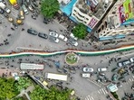 An aerial view shows school students carrying a large Indian national flag on a road during the 'Har Ghar Tiranga' campaign on the eve of the country's Independence Day celebrations in Vijayawada on August 14, 2024. (Photo by Idrees MOHAMMED / AFP) An aerial view shows school students carrying a large Indian national flag on a road during the 'Har Ghar Tiranga' campaign on the eve of the country's Independence Day celebrations in Vijayawada on August 14, 2024. (Photo by Idrees MOHAMMED / AFP)