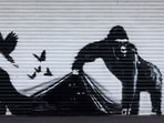 An artwork by street artist Banksy, the ninth to released in nine days, depicts a gorilla releasing animals, on the front of a shutter outside London zoo.(AFP) An artwork by street artist Banksy, the ninth to released in nine days, depicts a gorilla releasing animals, on the front of a shutter outside London zoo.(AFP)