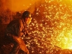 An employee works next to molten iron at a steel mill of Dongbei Special Steel in Dalian, Liaoning province, China. (Stringer/REUTERS) An employee works next to molten iron at a steel mill of Dongbei Special Steel in Dalian, Liaoning province, China. (Stringer/REUTERS)