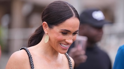 Meghan Markle is thought to be plotting a bombshell memoir to reveal her side of the story amid her and Prince Harry's feud with the royal family (AP)