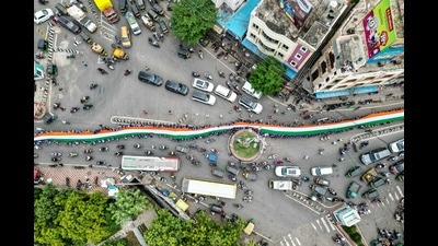 TOPSHOT - An aerial view shows school students carrying a large Indian national flag on a road during the 'Har Ghar Tiranga' campaign on the eve of the country's Independence Day celebrations in Vijayawada on August 14, 2024. (Photo by Idrees MOHAMMED / AFP) (AFP) TOPSHOT - An aerial view shows school students carrying a large Indian national flag on a road during the 'Har Ghar Tiranga' campaign on the eve of the country's Independence Day celebrations in Vijayawada on August 14, 2024. (Photo by Idrees MOHAMMED / AFP) (AFP)