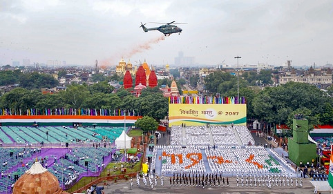 Helicopter showers flower petals on participants of the Dress Rehearsal for Independence Day. (PTI) Helicopter showers flower petals on participants of the Dress Rehearsal for Independence Day. (PTI)