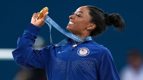 Simone Biles, of the United States, celebrates after winning the gold medal during the women's artistic gymnastics all-around finals in Bercy Arena(AP)