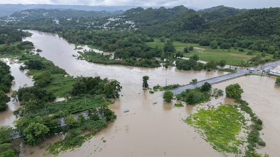 La Plata river floods a road after Tropical Storm Ernesto passed through Toa Baja, Puerto Rico, Wednesday, Aug. 14, 2024. (AP Photo/Alejandro Granadillo)(AP)