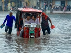 A vehicle moves through a waterlogged Sikar road following heavy monsoon rain in Jaipur on Monday. (PTI)(HT_PRINT)