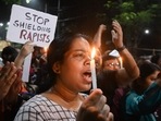 Medical professionals and activists in Kolkata hold posters and candles as they take part in a midnight protest to condemn the rape and murder of a young medic.(AFP) Medical professionals and activists in Kolkata hold posters and candles as they take part in a midnight protest to condemn the rape and murder of a young medic.(AFP)