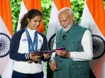 Prime Minister Narendra Modi with bronze medallist shooter Manu Bhaker during his interaction with the Indian contingent.