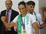 Gold medalist in the the women's 66 kg boxing Algeria's Imane Khelif, left, and bronze medalist in the men's 800m Djamel Sedjati arrive after the 2024 Summer Olympics, Monday, Aug. 12, 2024, at Algiers airport, Algeria. (AP) Gold medalist in the the women's 66 kg boxing Algeria's Imane Khelif, left, and bronze medalist in the men's 800m Djamel Sedjati arrive after the 2024 Summer Olympics, Monday, Aug. 12, 2024, at Algiers airport, Algeria. (AP)