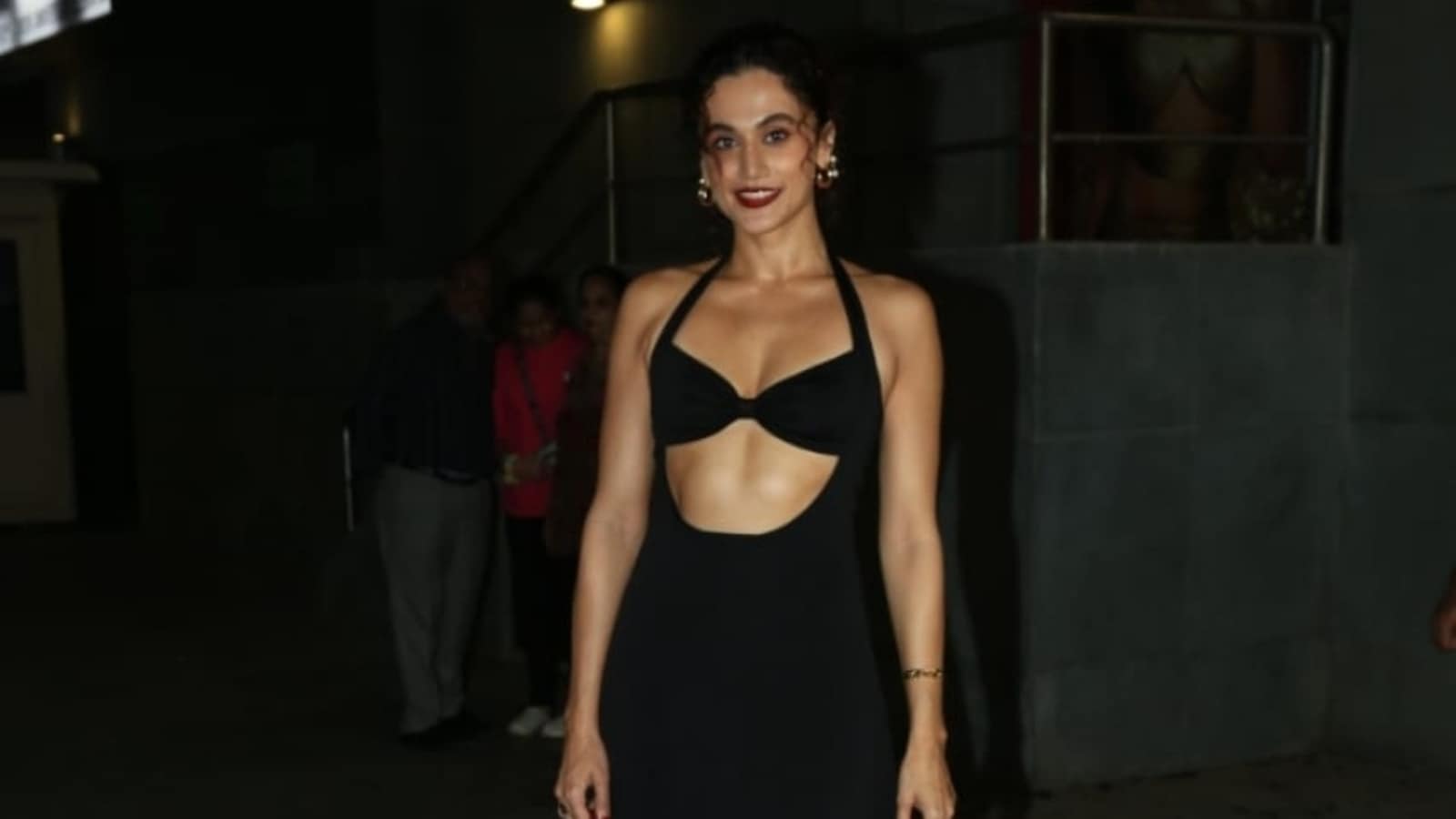 Taapsee Pannu looks bewitching in a black cut-out dress and bold red lips. It is worth ₹32k