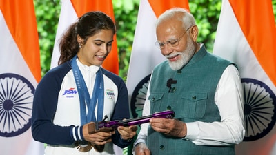 Prime Minister Narendra Modi with bronze medallist shooter Manu Bhaker during his interaction with the Indian contingent for Paris Olympics, in New Delhi, Thursday, (PTI) Prime Minister Narendra Modi with bronze medallist shooter Manu Bhaker during his interaction with the Indian contingent for Paris Olympics, in New Delhi, Thursday, (PTI)
