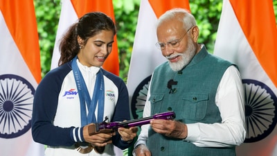 Prime Minister Narendra Modi with bronze medallist shooter Manu Bhaker during his interaction with the Indian contingent. (PTI) Prime Minister Narendra Modi with bronze medallist shooter Manu Bhaker during his interaction with the Indian contingent. (PTI)
