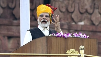 Last year, PM Modi opted for a vibrant Rajasthani-style turban featuring multiple colours and a lengthy tail. He completed the look with an off-white kurta, white trousers, and a jacket enhanced by a pocket square. (File Photo/ANI) Last year, PM Modi opted for a vibrant Rajasthani-style turban featuring multiple colours and a lengthy tail. He completed the look with an off-white kurta, white trousers, and a jacket enhanced by a pocket square. (File Photo/ANI)