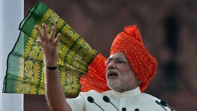 For his first Independence Day speech in 2014, PM Modi chose a traditional orange, yellow, and green Rajasthani turban. He complemented the headgear with a cream kurta and pyjama set. (File Photo) For his first Independence Day speech in 2014, PM Modi chose a traditional orange, yellow, and green Rajasthani turban. He complemented the headgear with a cream kurta and pyjama set. (File Photo)