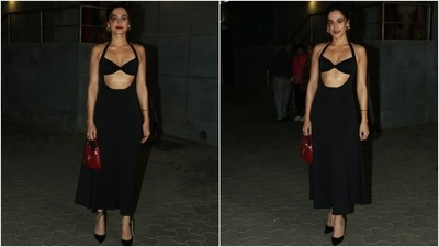 Taapsee Pannu wore a black halter-neck midi dress to the premiere of Khel Khel Mein. She styled the cut-out ensemble with bold red lips, Jimmy Choo stilettos, a red Gucci bag, hoop earrings, and a messy top knot. (HT Photo/Varinder Chawla) Taapsee Pannu wore a black halter-neck midi dress to the premiere of Khel Khel Mein. She styled the cut-out ensemble with bold red lips, Jimmy Choo stilettos, a red Gucci bag, hoop earrings, and a messy top knot. (HT Photo/Varinder Chawla)