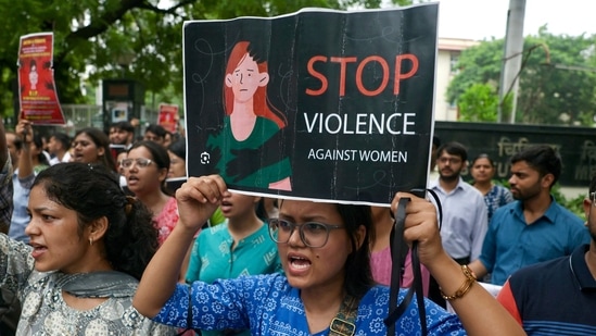 Medical students shout slogans and hold posters as they protest the rape and murder of a young medic from Kolkata.(AFP)