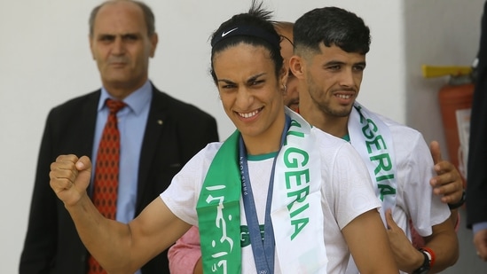 Gold medalist in the the women's 66 kg boxing Algeria's Imane Khelif, left, and bronze medalist in the men's 800m Djamel Sedjati arrive after the 2024 Summer Olympics, Monday, Aug. 12, 2024, at Algiers airport, Algeria. (AP)