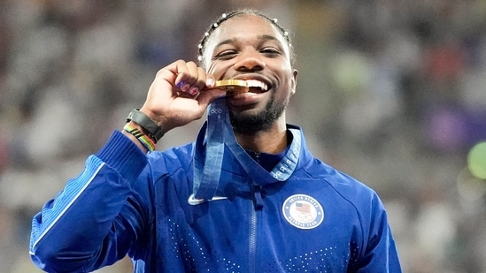 Gold medalist, Noah Lyles, of the United States, poses on the podium after the men's 100-meter final at the 2024 Summer Olympics, Monday, Aug. 5, 2024, in Saint-Denis, France. (AP Photo/Matthias Schrader, File)(AP)