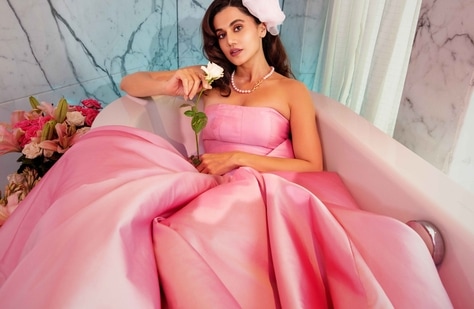 Taapsee Pannu exudes old Hollywood glamour in this dusty pink gown from Maison Tai. The strapless gown has been further spruced up with a pearl neckpiece and a rosette hair pink to complete the look. 