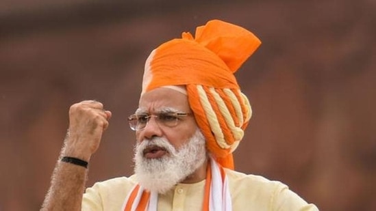 In 2020, PM Modi wore a saffron and cream turban to complement the orange and white scarf draped over his shoulders. He paired them with a cream-coloured kurta and pants set.&nbsp;(File Photo/PTI)