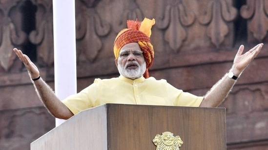 To address the nation on Independence Day in 2017, Modi wore yet another yellow turban with shades of scarlet and intricate geometric patterns. He complemented the headgear with a cream-coloured kurta-pyjama set.&nbsp;(Arun Sharma/Hindustan Times)