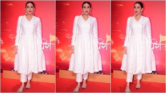 Karisma made heads turn at the NMACC event in a regal ivory silk angrakha kurta set. She wore an angrakha-style anarkali kurta and pants set for the affair. Red lips, jhumkis, embellished juttis, and a centre-parted bun completed the look.&nbsp;(HT Photo/Varinder Chawla)
