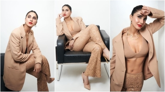 Vaani Kapoor attended the premiere of Khel Khel Mein in an all-beige look. Vaani wore a ribbed bikini top, lace-embroidered flared pants, and an oversized blazer. She styled the ensemble with red lips, hoop earrings, a layered necklace, a sleek bun, nude pumps, and striking glam.&nbsp;(Instagram)
