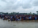 Cooch Behar: Bangladeshi nationals assemble close to the Sitalkuchi fenced land border in Cooch Behar in their bid to crossover to India. (PTI Photo)(PTI) Cooch Behar: Bangladeshi nationals assemble close to the Sitalkuchi fenced land border in Cooch Behar in their bid to crossover to India. (PTI Photo)(PTI)