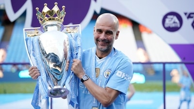 Manchester City's head coach Pep Guardiola celebrates with the Premier League trophy. (AP) Manchester City's head coach Pep Guardiola celebrates with the Premier League trophy. (AP)