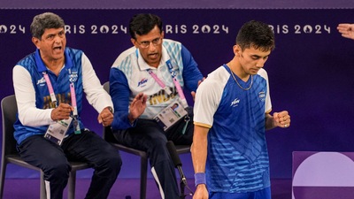 Coaches Prakash Padukone (L) and Vimal Kumar (C) egging Lakshya Sen (R) on during his bronze-medal match. (PTI) Coaches Prakash Padukone (L) and Vimal Kumar (C) egging Lakshya Sen (R) on during his bronze-medal match. (PTI)