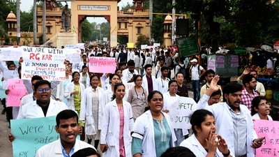 Resident doctors of BHU take part in a march demanding justice for RG Kar Medical College rape and murder victim in Varanasi on Friday. (PTI) Resident doctors of BHU take part in a march demanding justice for RG Kar Medical College rape and murder victim in Varanasi on Friday. (PTI)