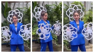 Uorfi Javed who's known for testing the fashion bar every day with her unconventional styling, wore a blue pantsuit, with a bizzarre twist. &nbsp;Attached to her back and her hands, she flaunted spirals that spun like fans. 