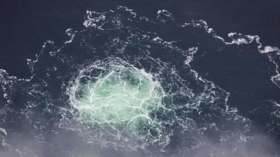 (FILES) This file handout photo taken on September 28, 2022 from an aircraft of the Swedish Coast Guard (Kustbevakningen) shows the release of gas emanating from a leak on the Nord Stream 2 gas pipeline, in the Swedish economic zone in the Baltic Sea. (AFP)