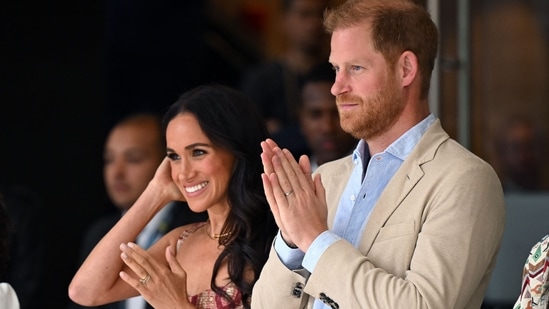 Britain's Prince Harry (C), Duke of Sussex, and his wife Meghan Markle react while attending a show during a visit to the National Centre for the Arts in Bogota on August 15, 2024. Prince Harry and his wife, American actress Meghan Markle, arrived in Colombia at the invitation of Marquez, with whom they will attend various meetings with women and young people to reject discrimination and cyberbullying. (Photo by RAUL ARBOLEDA / AFP)(AFP)