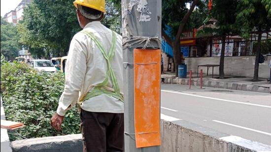 Over 25,000 junction boxes, located around 4-6ft high on streetlights, have been covered using PVC sheets in the past two weeks. (HT Photo)