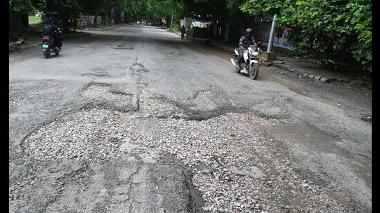 The main road of Sector-56 connecting Golf Course Road to Sector 56 is in very bad condition due to rains near Huda Market in Gurugram. (Parveen Kumar/HT PHOTO)