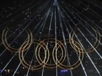 Lights illuminate the Olympic rings during a performance at the closing ceremony of the Paris Olympics. (PTI) Lights illuminate the Olympic rings during a performance at the closing ceremony of the Paris Olympics. (PTI)
