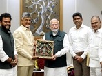 Prime Minister Narendra Modi being presented a memento by Andhra Pradesh CM N Chandrababu Naidu, in New Delhi on Saturday. (ANI)
