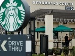 A worker puts away patio furniture at a Starbucks Corp drive-through location in Oceanside, California, U,S. May 29, 2018 (Mike Blake/Reuters)