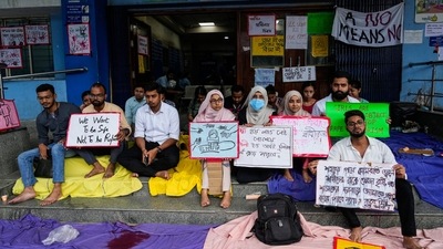 Doctors and interns sit on a strike for 24 hours at the entrance of a government hospital in a protest against last week's rape and killing of a trainee doctor at a government hospital, in Kolkata, (AP) Doctors and interns sit on a strike for 24 hours at the entrance of a government hospital in a protest against last week's rape and killing of a trainee doctor at a government hospital, in Kolkata, (AP)