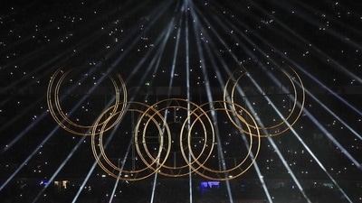 Lights illuminate the Olympic rings during a performance at the closing ceremony of the Paris Olympics. (PTI) Lights illuminate the Olympic rings during a performance at the closing ceremony of the Paris Olympics. (PTI)
