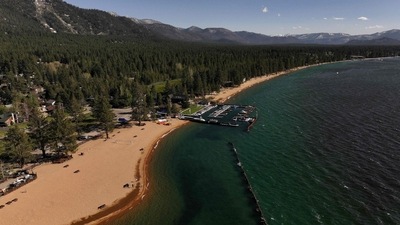 In an aerial view, Lake Tahoe is seen at near full capacity at Lakeside Beach on May 22, 2024 in South Lake Tahoe, California. (Justin Sullivan/Getty Images via AFP) In an aerial view, Lake Tahoe is seen at near full capacity at Lakeside Beach on May 22, 2024 in South Lake Tahoe, California. (Justin Sullivan/Getty Images via AFP)