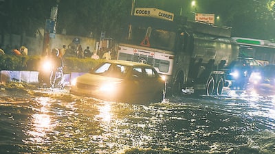vehicles pass through waterlogged road at near Pune collector’s office on Saturday. (MAHENDRA KOLHE/HT PHOTO) vehicles pass through waterlogged road at near Pune collector’s office on Saturday. (MAHENDRA KOLHE/HT PHOTO)