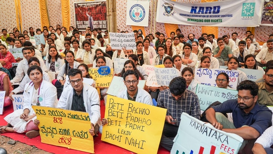 Doctors hold placards during a protest at the Freedom Park in Bengaluru on Friday.(PTI)