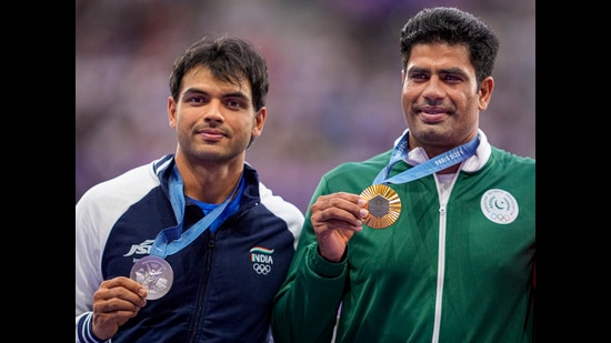 Paris: Gold medalist Pakistan’s Arshad Nadeem (R) and Silver medalist India’s Neeraj Chopra pose for photos at the podium during the victory ceremony for the men's javelin throw final event at the 2024 Summer Olympics, in Paris, France, Friday, Aug. 9, 2024. (PTI Photo/Ravi Choudhary) (PTI)