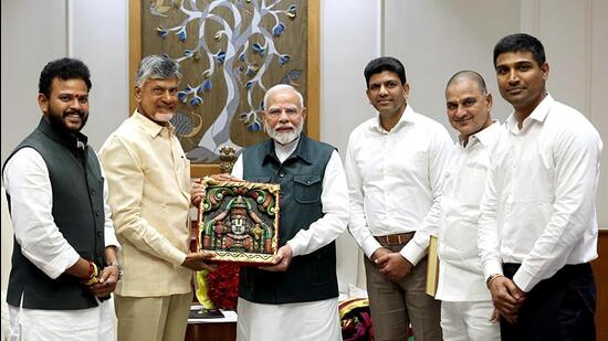 Prime Minister Narendra Modi being presented a memento by Andhra Pradesh CM N Chandrababu Naidu, in New Delhi on Saturday. (ANI)