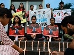 Medical professionals light candles as they pay tribute to a victim of the rape and murder of a young medic from Kolkata, in Amritsar on August 18, 2024. (Photo by Narinder NANU / AFP)(AFP)