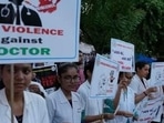 Kolkata rape-murder: Doctors and medical students hold placards and candles during a protest (AP Photo)