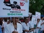 Kolkata rape-murder: Doctors and medical students hold placards and candles during a protest (AP Photo) Kolkata rape-murder: Doctors and medical students hold placards and candles during a protest (AP Photo)