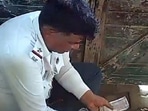 Three traffic policemen were caught on camera dividing money they took as a bribe. (Screengrab)